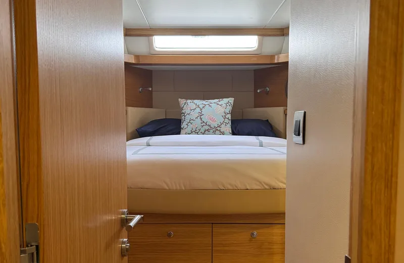 Oasis Yacht Photos Pics Luxurious bedroom interior of 2021 Outer Reef Trident 620 yacht with elegant bedding.