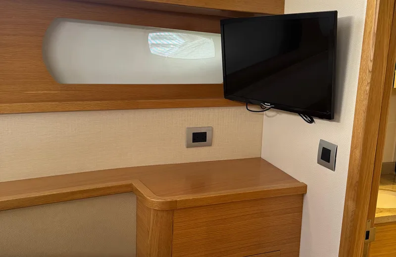 Oasis Yacht Photos Pics Modern cabin interior of 2021 Outer Reef Trident 620 yacht with mounted TV.