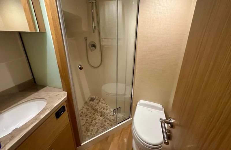 Oasis Yacht Photos Pics Luxurious bathroom in 2021 Outer Reef Trident 620 yacht with shower and toilet.