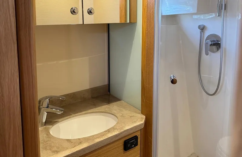 Oasis Yacht Photos Pics 2021 Outer Reef Trident 620 yacht bathroom with modern sink and shower.