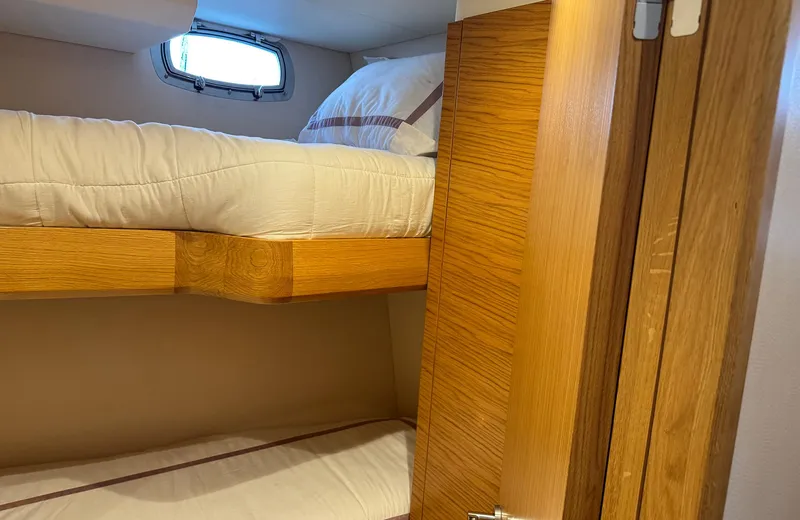 Oasis Yacht Photos Pics Bunk beds in 2021 Outer Reef Trident 620 yacht cabin with wooden interior.