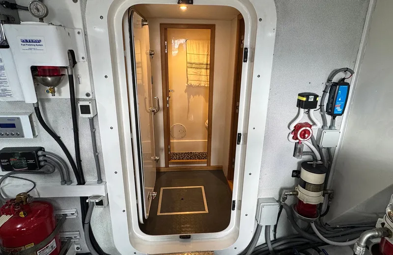 Oasis Yacht Photos Pics Engine room door of 2021 Outer Reef Trident 620 yacht, showcasing interior and equipment.