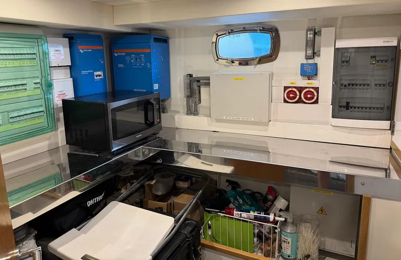 Oasis Yacht Photos Pics Engine room of 2021 Outer Reef Trident 620 yacht with equipment and storage.