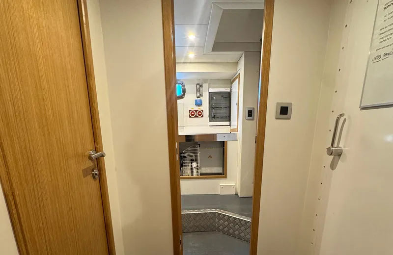 Oasis Yacht Photos Pics Interior view of 2021 Outer Reef Trident 620 yacht, featuring modern design and wood finishes.