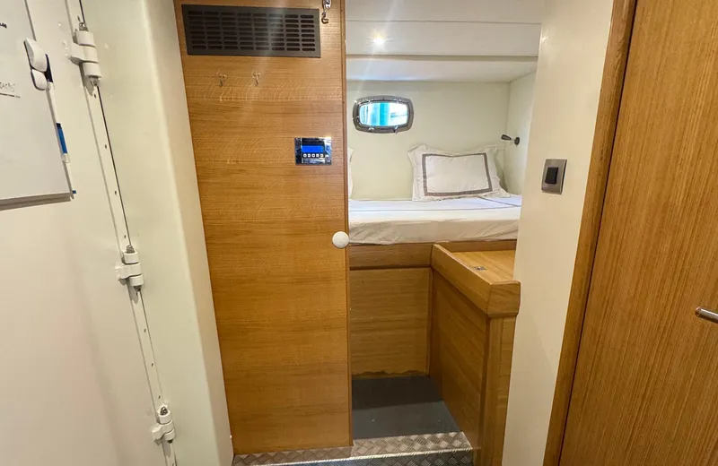 Oasis Yacht Photos Pics 2021 Outer Reef Trident 620 cabin interior with wooden finish and cozy bed.
