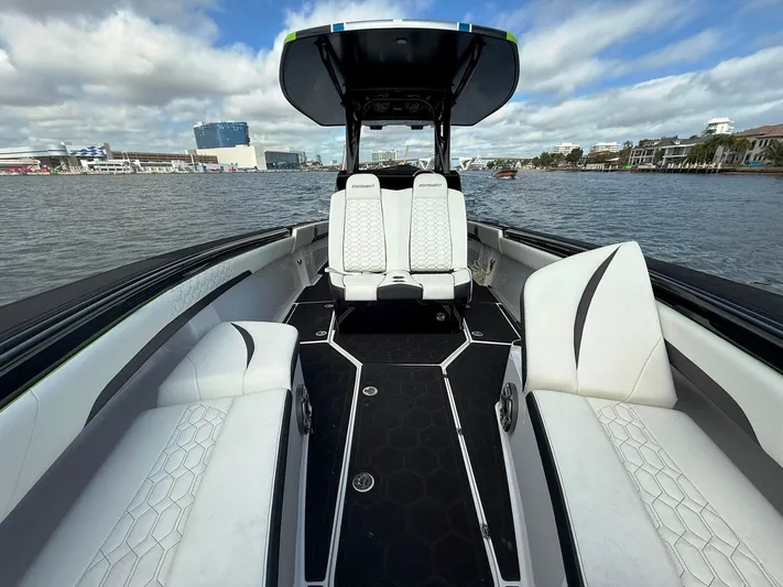  Yacht Photos Pics 2024 Statement 350 Open boat interior with white seating on a calm water backdrop.