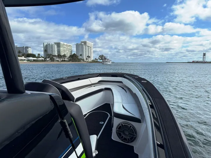  Yacht Photos Pics 2024 Statement 350 Open boat on water with city skyline in background.