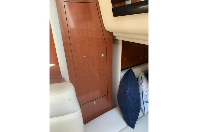 Maximus Yacht Photos Pics Interior cabin of 2005 Sea Ray 340 Sundancer with wooden cabinetry and cushions.