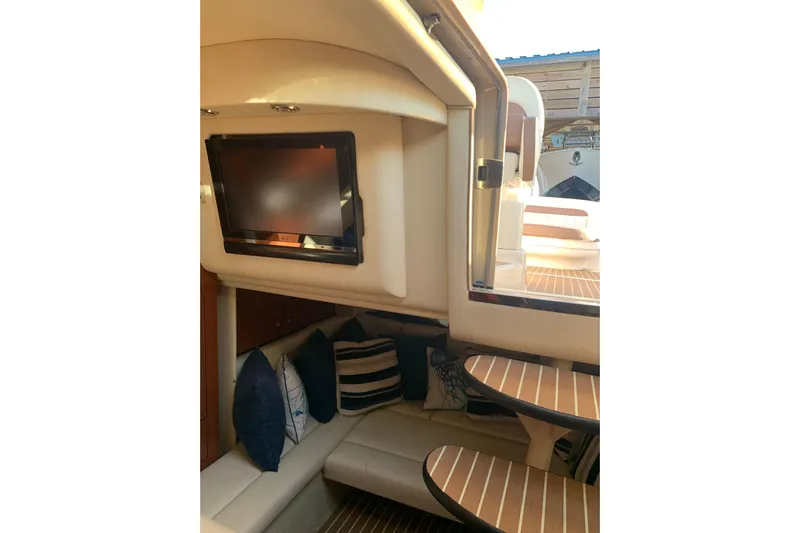 Maximus Yacht Photos Pics 2005 Sea Ray 340 Sundancer interior with TV, seating, and wooden accents.
