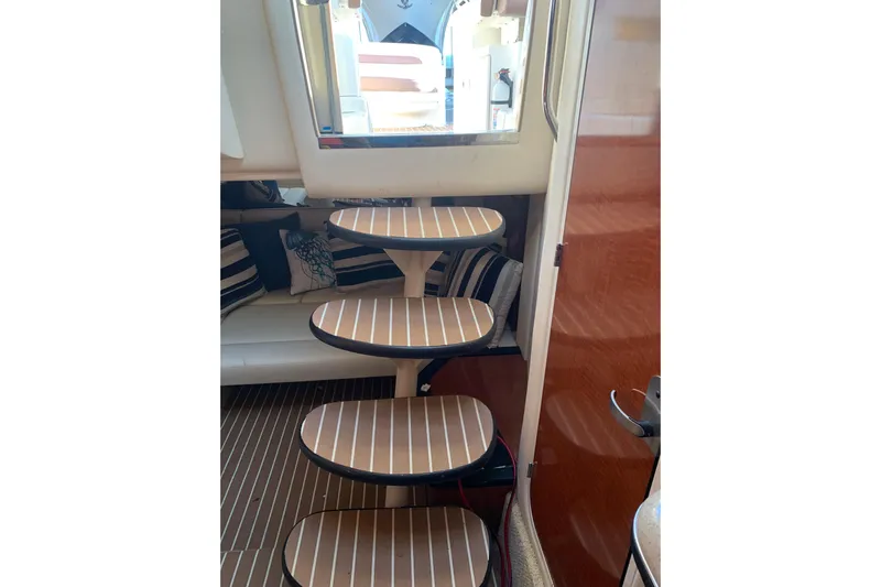 Maximus Yacht Photos Pics Interior stairs of 2005 Sea Ray 340 Sundancer yacht with striped cushions.