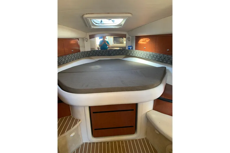 Maximus Yacht Photos Pics 2005 Sea Ray 340 Sundancer cabin interior with bed and storage cabinets.