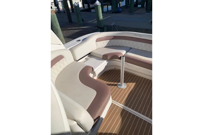 Maximus Yacht Photos Pics 2005 Sea Ray 340 Sundancer boat interior with cushioned seating and wooden deck.