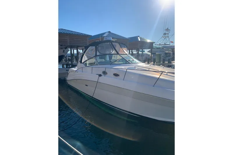 Maximus Yacht Photos Pics 2005 Sea Ray 340 Sundancer docked under clear blue sky.