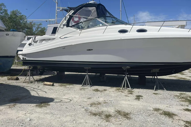 Maximus Yacht Photos Pics 2005 Sea Ray 340 Sundancer yacht on stands in a boatyard.