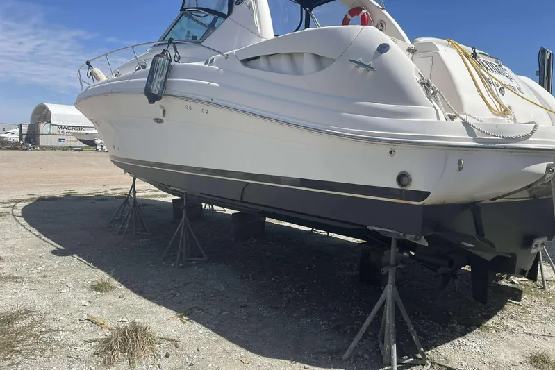 Maximus Yacht Photos Pics 2005 Sea Ray 340 Sundancer yacht on stands, outdoor storage, clear sky background.