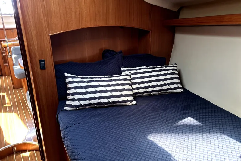Island Myst II Yacht Photos Pics Cozy cabin interior of 2007 Hunter 41 Deck Salon with striped pillows and wooden accents.