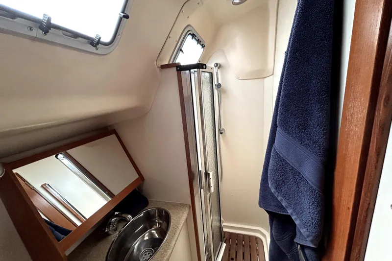 Island Myst II Yacht Photos Pics 2007 Hunter 41 Deck Salon bathroom with shower, sink, and towel.