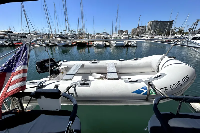 Island Myst II Yacht Photos Pics Hunter 41 Deck Salon 2007 yacht with inflatable dinghy in marina, American flag visible.