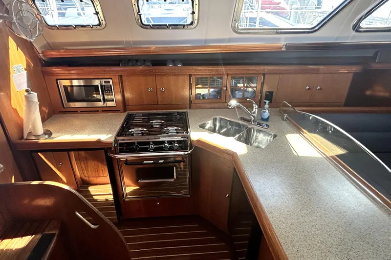 Island Myst II Yacht Photos Pics 2007 Hunter 41 Deck Salon kitchen with stove, microwave, and sink.
