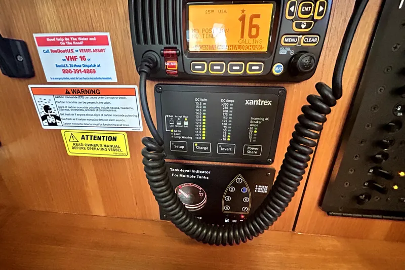 Island Myst II Yacht Photos Pics Control panel of a 2007 Hunter 41 Deck Salon with VHF radio and warning labels.