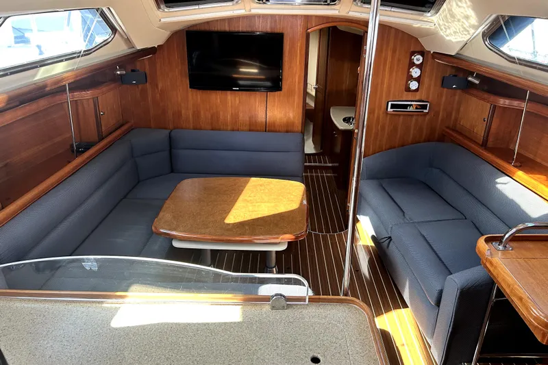 Island Myst II Yacht Photos Pics 2007 Hunter 41 Deck Salon interior with blue seating, wooden table, and modern amenities.