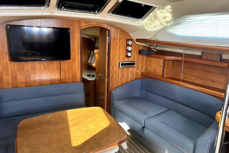 Island Myst II Yacht Photos Pics Interior of 2007 Hunter 41 Deck Salon with cozy seating and wooden finishes.