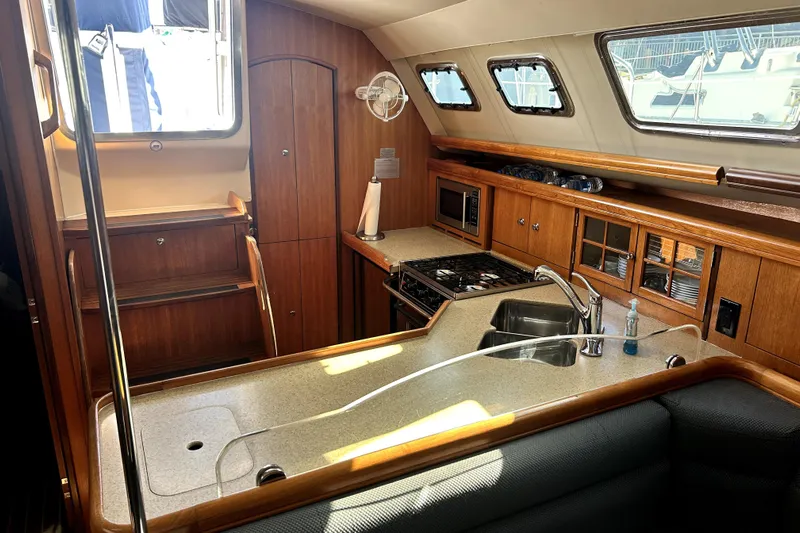 Island Myst II Yacht Photos Pics Interior of 2007 Hunter 41 Deck Salon yacht, featuring a well-equipped kitchen area.