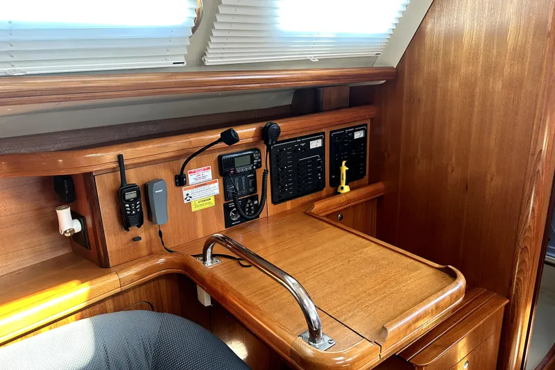 Island Myst II Yacht Photos Pics 2007 Hunter 41 Deck Salon navigation station with wood finish and communication equipment.