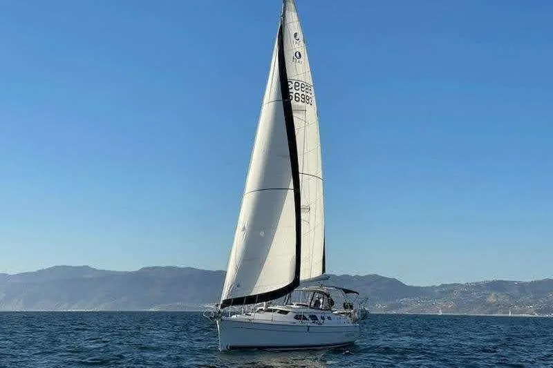 Island Myst II Yacht Photos Pics Sailing yacht Hunter 41 Deck Salon 2007 on open water with mountains in background.