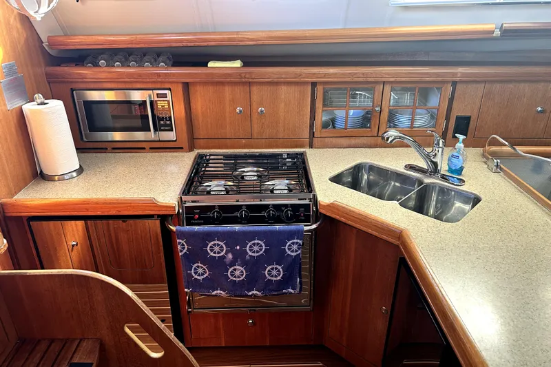 Island Myst II Yacht Photos Pics Galley kitchen in 2007 Hunter 41 Deck Salon yacht with stove, microwave, and sink.