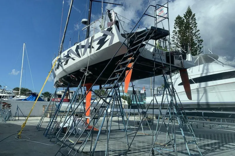 Zed4 Yacht Photos Pics 2009 Class 40 Akilaria RC2 sailboat on stands in a marina, clear sky background.