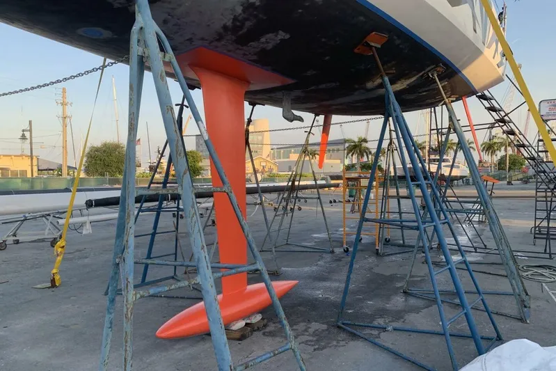 Zed4 Yacht Photos Pics Sailboat Akilaria RC2 (2009) on stands, showcasing its vibrant orange keel.