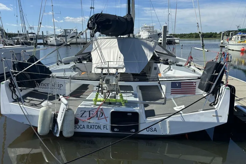 Zed4 Yacht Photos Pics 2009 Class 40 Akilaria RC2 sailboat docked, featuring American flag and Boca Raton, FL registration.