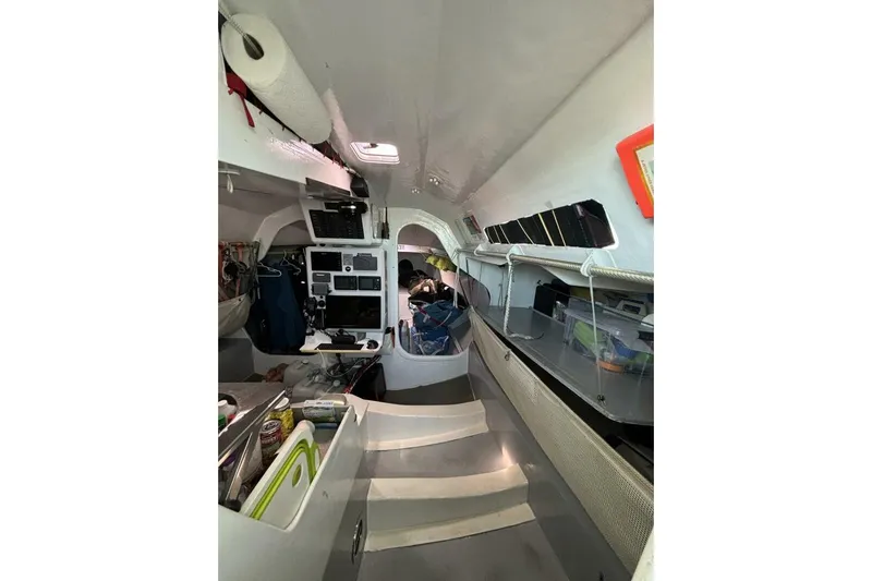 Zed4 Yacht Photos Pics Interior of 2009 Class 40 Akilaria RC2 sailboat, featuring navigation equipment and storage.