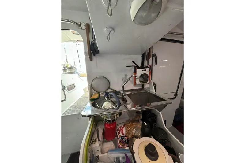 Zed4 Yacht Photos Pics Interior of 2009 Class 40 Akilaria RC2 yacht, featuring compact kitchen area.