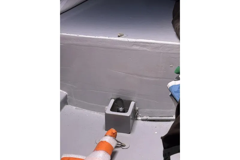 Zed4 Yacht Photos Pics Interior of 2009 Class 40 Akilaria RC2 sailboat, featuring a storage compartment and safety equipment.