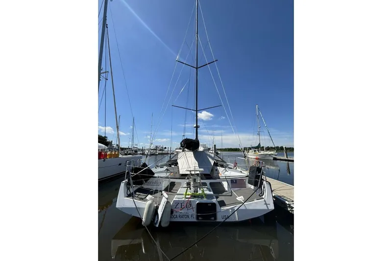 Zed4 Yacht Photos Pics 2009 Class 40 Akilaria RC2 sailboat docked under clear blue sky.