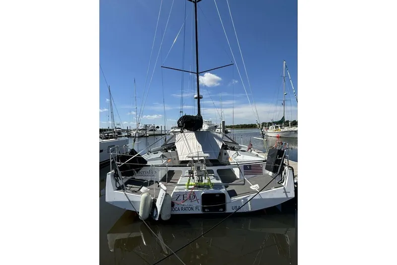 Zed4 Yacht Photos Pics 2009 Class 40 Akilaria RC2 sailboat docked at marina under clear blue sky.