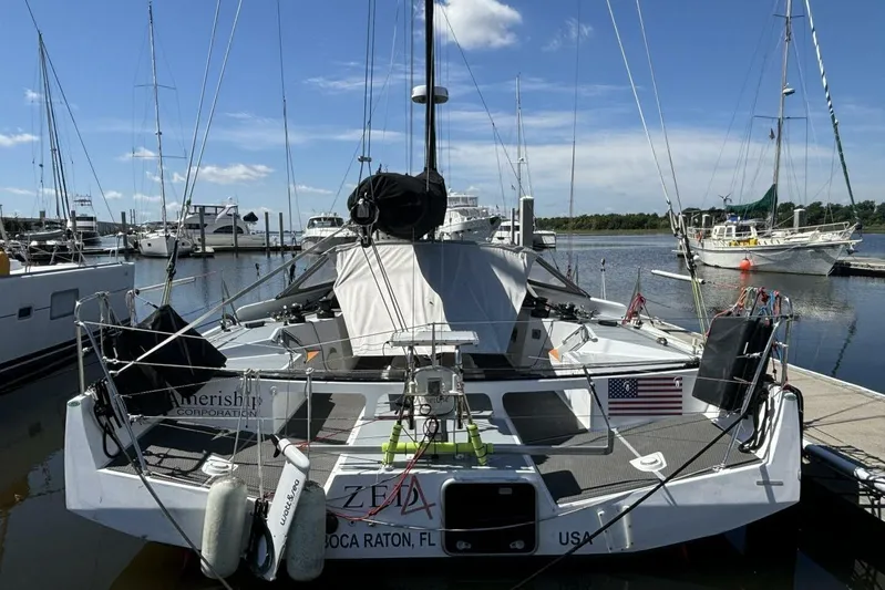 Zed4 Yacht Photos Pics Sailboat docked at marina, Class 40 Akilaria RC2, 2009 model, with American flag.