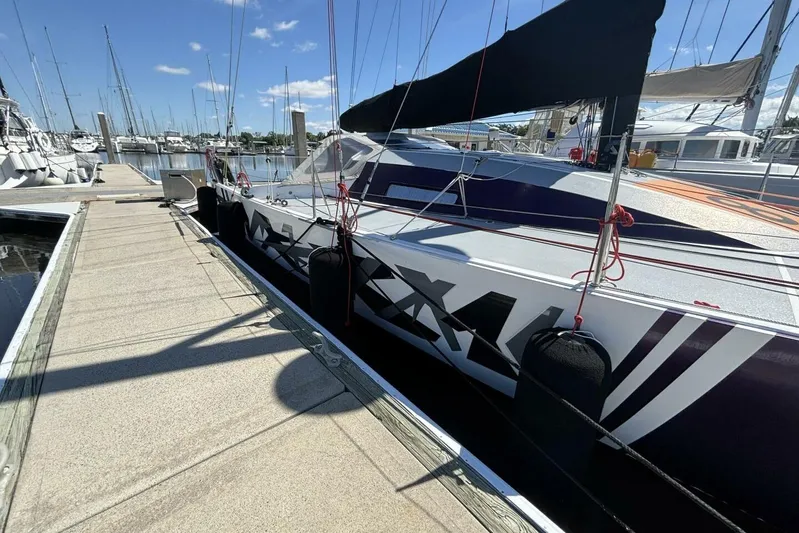 Zed4 Yacht Photos Pics 2009 Class 40 Akilaria RC2 sailboat docked at marina under clear blue sky.