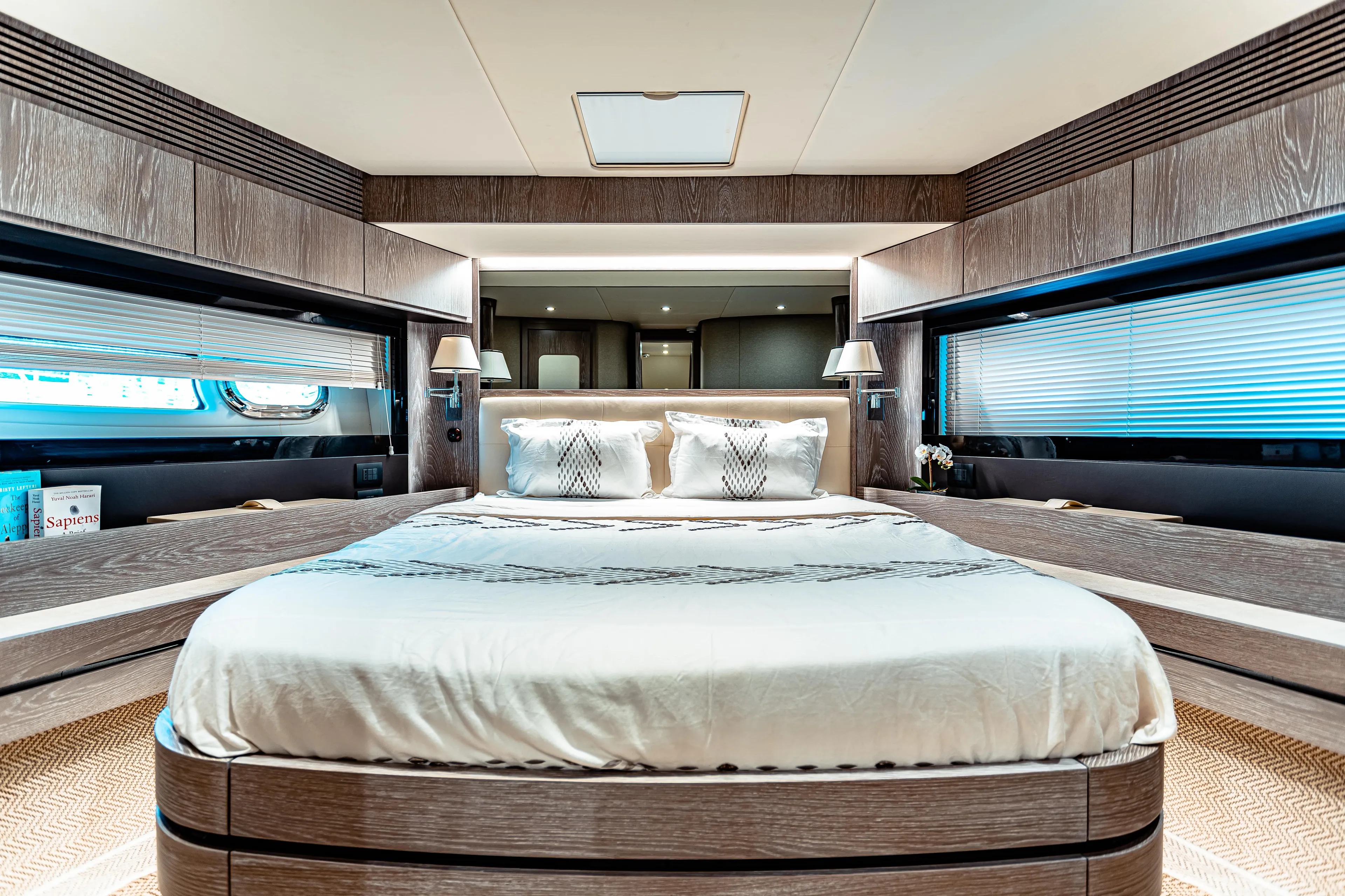 Fat Boy Yacht Photos Pics Luxurious bedroom interior of 2020 Azimut Magellano 66 yacht with elegant wood finishes.