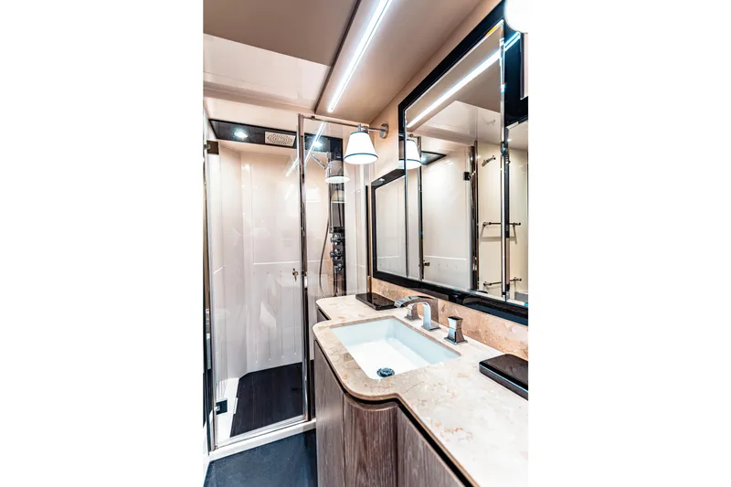 Fat Boy Yacht Photos Pics Luxurious bathroom in 2020 Azimut Magellano 66 yacht with modern fixtures and elegant design.