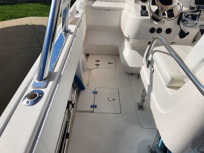  Yacht Photos Pics 2008 Intrepid 323 Cuddy boat interior with steering wheel and seating area.