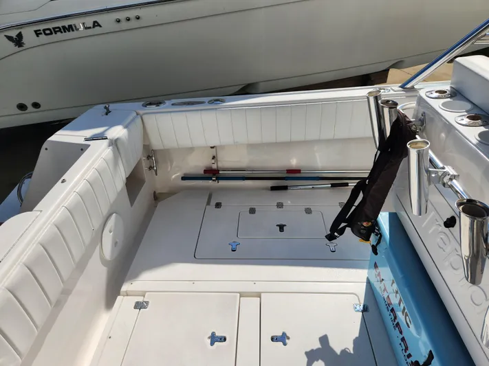  Yacht Photos Pics 2008 Intrepid 323 Cuddy boat interior with white seating and storage compartments.