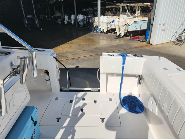  Yacht Photos Pics 2008 Intrepid 323 Cuddy boat interior with blue rope and storage compartments.