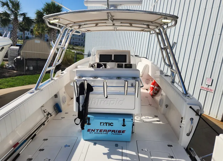  Yacht Photos Pics 2008 Intrepid 323 Cuddy boat interior with helm, seating, and storage, docked outdoors.