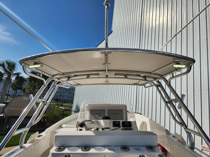  Yacht Photos Pics 2008 Intrepid 323 Cuddy boat with T-top and modern navigation equipment, docked near a building.