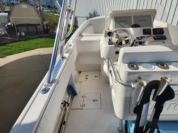  Yacht Photos Pics 2008 Intrepid 323 Cuddy boat interior with steering console and seating area.