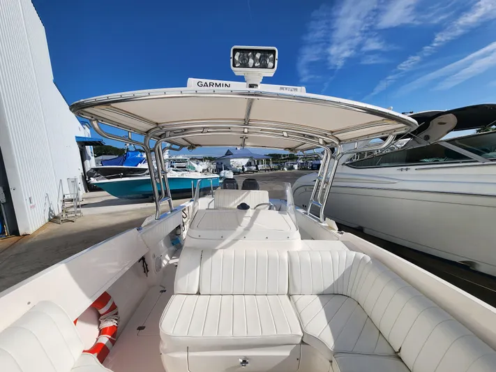  Yacht Photos Pics 2008 Intrepid 323 Cuddy boat with white seating and Garmin equipment, docked under blue sky.