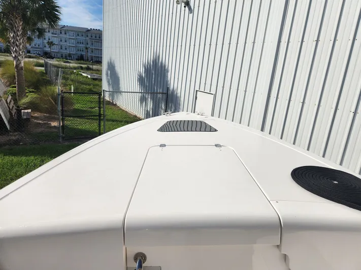  Yacht Photos Pics 2008 Intrepid 323 Cuddy boat docked beside a metal building.